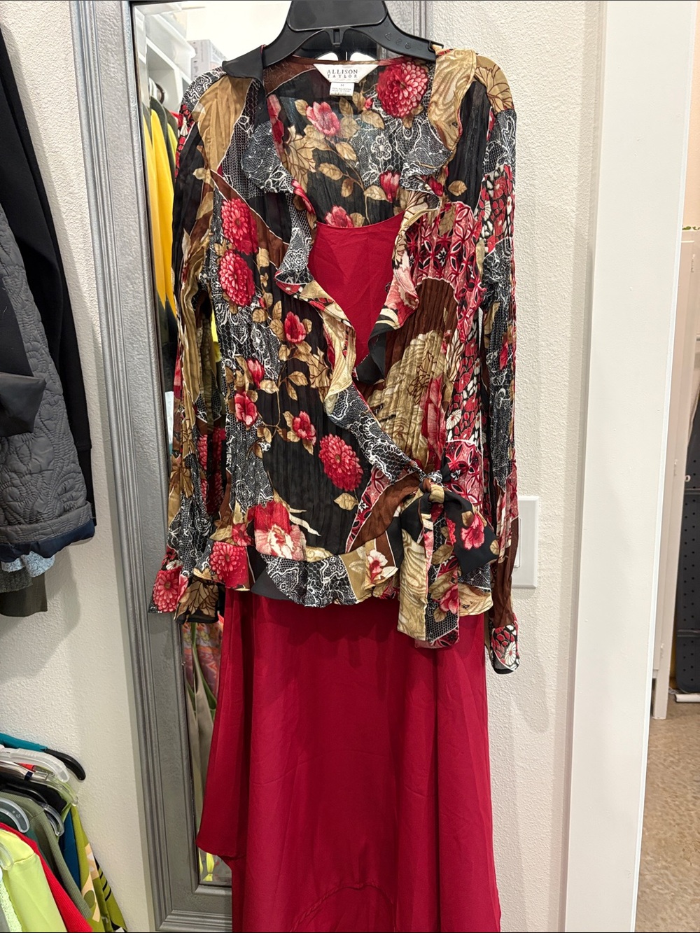 Allison Daley Black Floral Ruffle Blouse with Red dress under